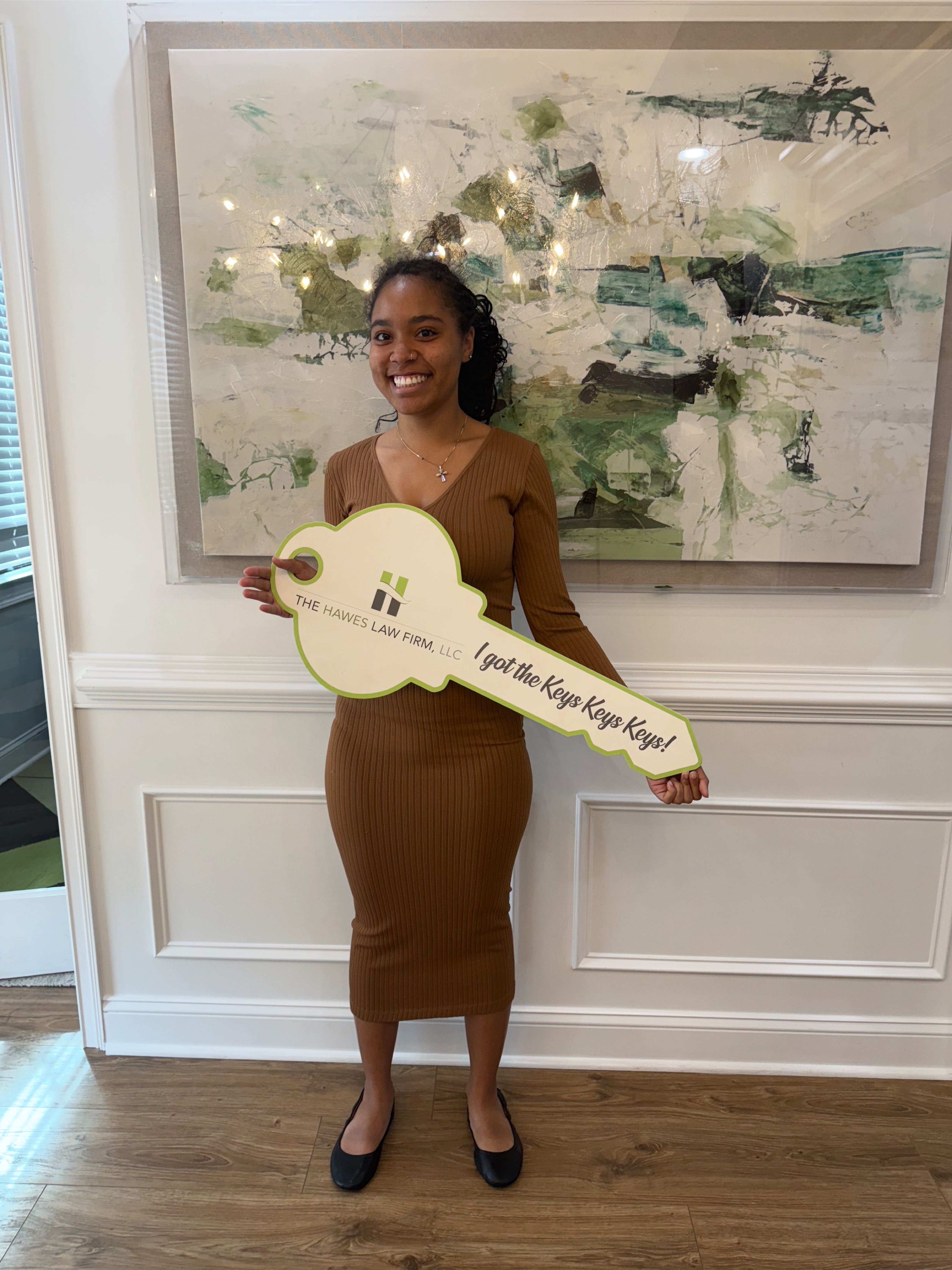 Jacqueline Walker's buyer Andrea F. holding her keys after closing on her townhome.