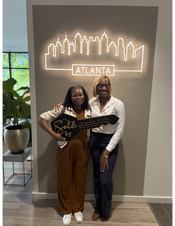 Jacqueline Walker with seller Crystal T. celebrating a sold listing.