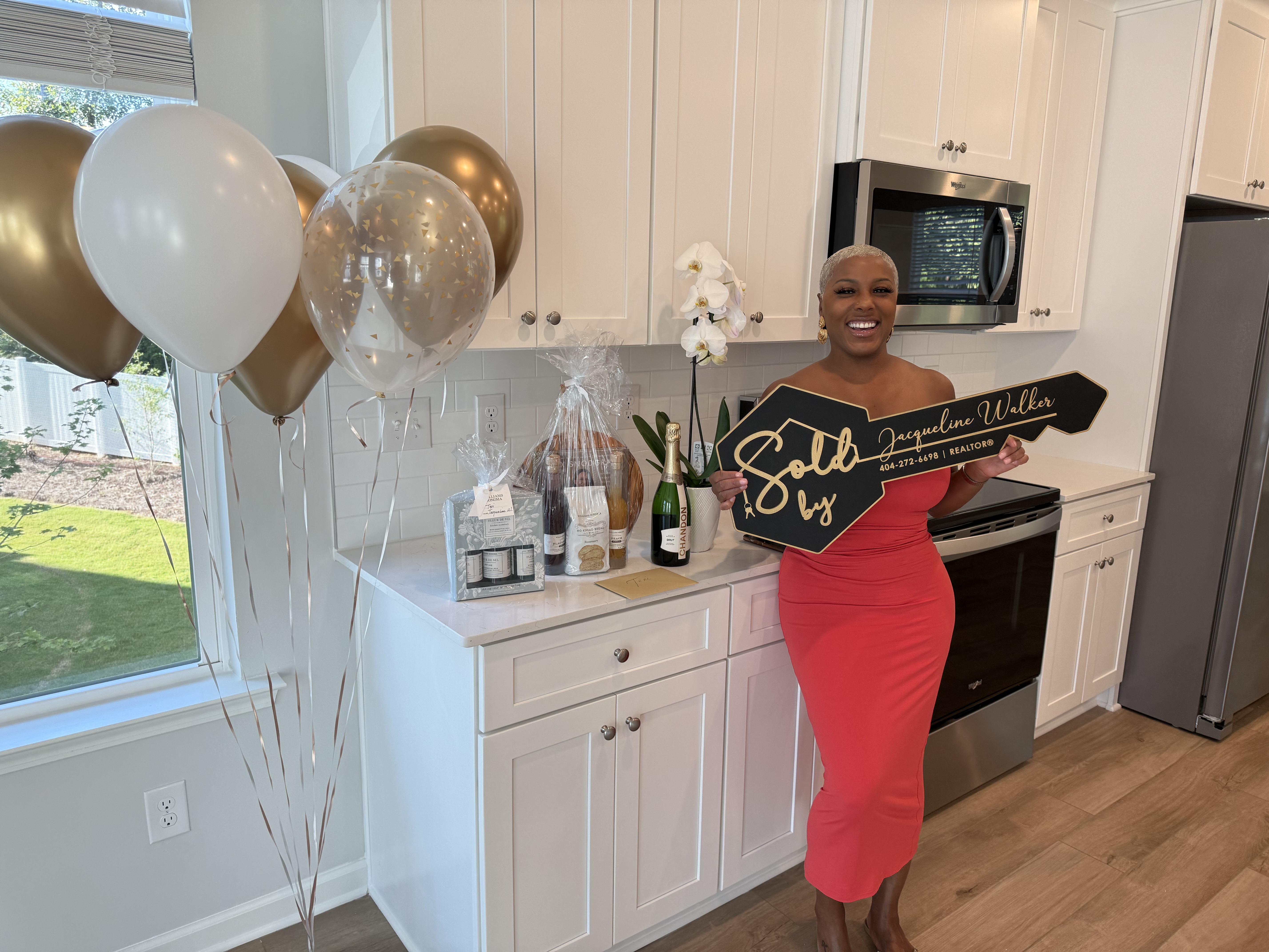 Jacqueline Walker with buyer Teri L. celebrating in her new kitchen.